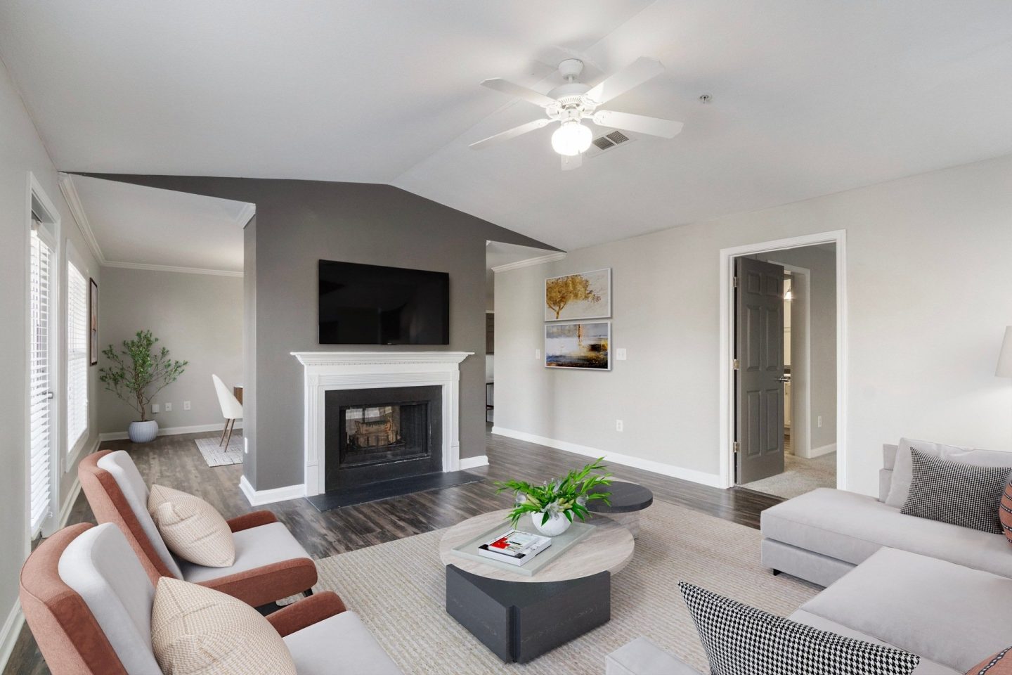 Living room with fireplace, mounted TV, and seating area at Windsor Kennesaw, 1925 Old 41 Highway Northwest, Kennesaw, GA 30152