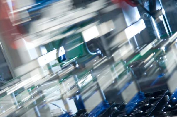 High-speed manufacturing machine parts in motion for production efficiency and scheduling optimization.