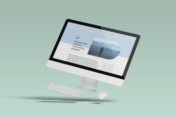 An image of a computer with a mouse and keyboard with the screen featuring the Sapere website.