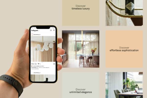 Hand holding a smartphone displaying A Beautiful Day brand interior design Instagram post. Background features images of modern, elegant interiors with text: "Discover timeless luxury," "effortless sophistication," "unlimited elegance.