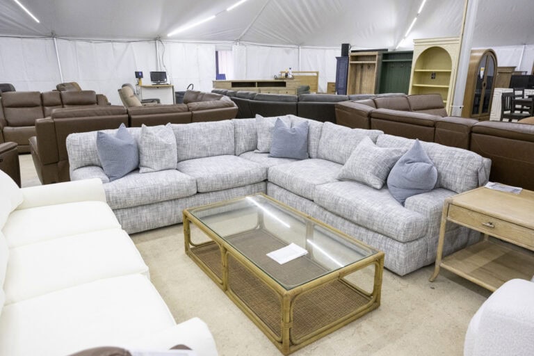 Elegant sectional sofa with neutral upholstery and decorative pillows at Woodchucks Furniture.