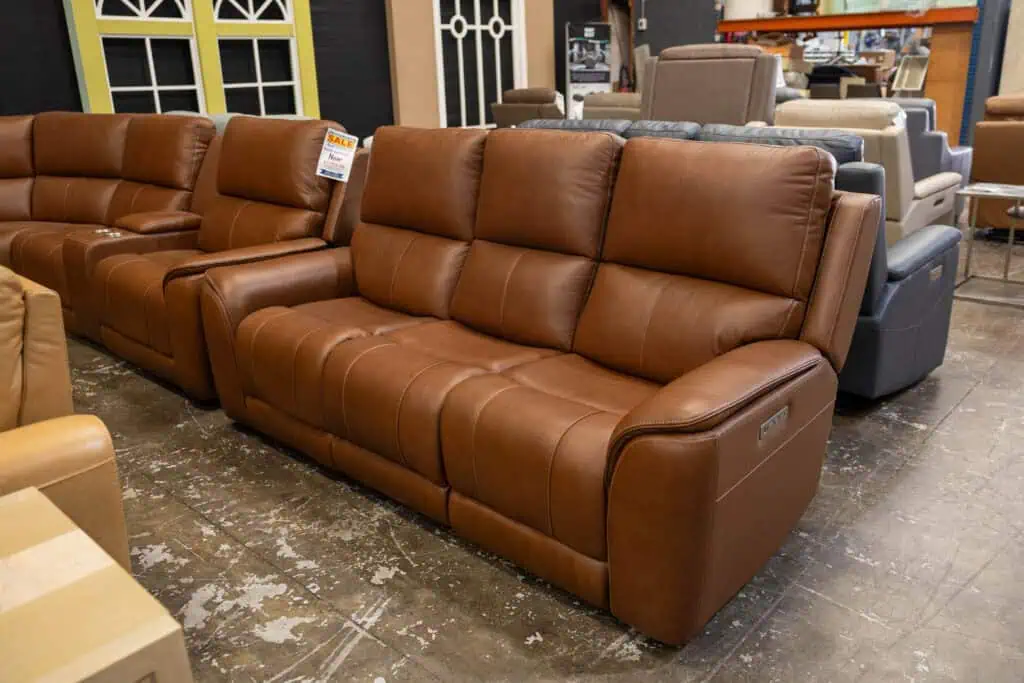 Brown leather reclining sofa in a furniture store.
