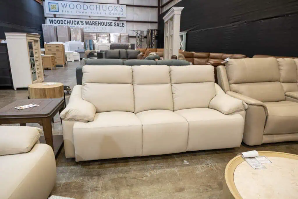 Cream-colored sofa with plush cushions in furniture store.