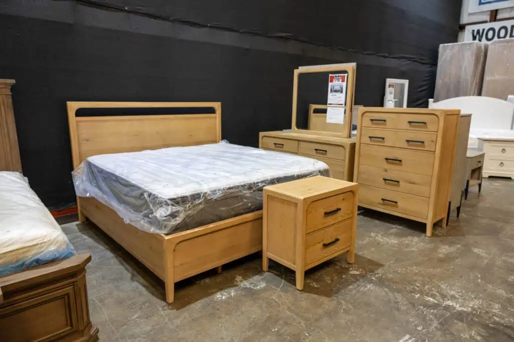 Wooden bedroom furniture set including bed, dresser, mirror, and nightstand.