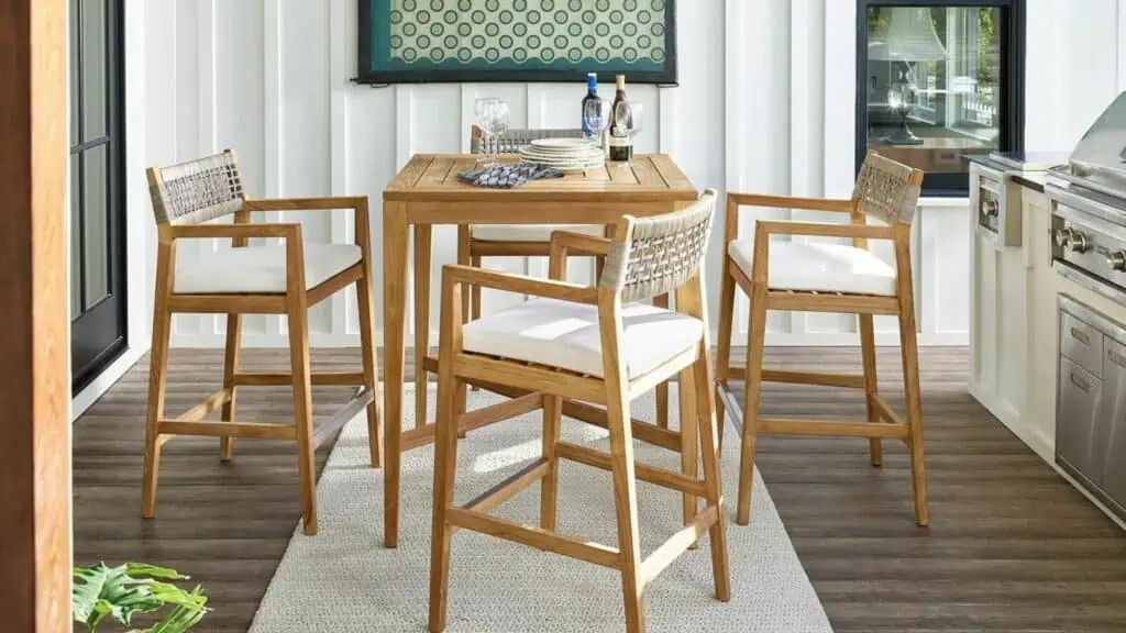 A hightop outdoor table and four tall stools