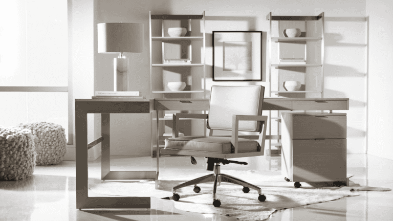 Modern office space with a desk, chair, and shelves in neutral tones.