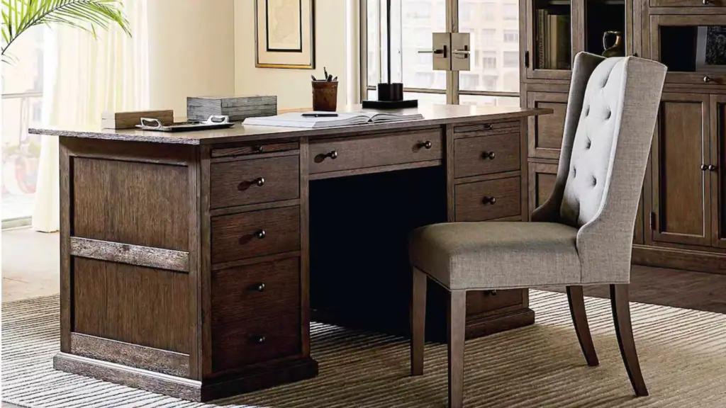 Dark brown wood desk with an upholstered chair