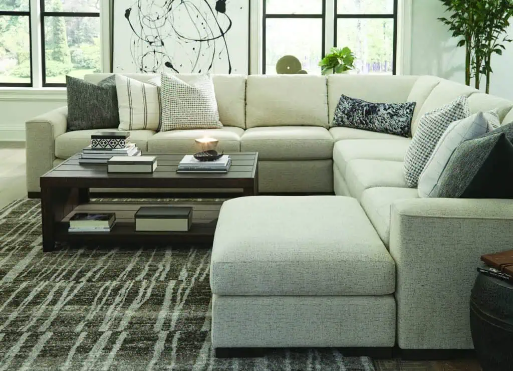 Comfortable L-shaped sofa in a bright living room with large windows, perfect for a home that adapts to your changing needs.
