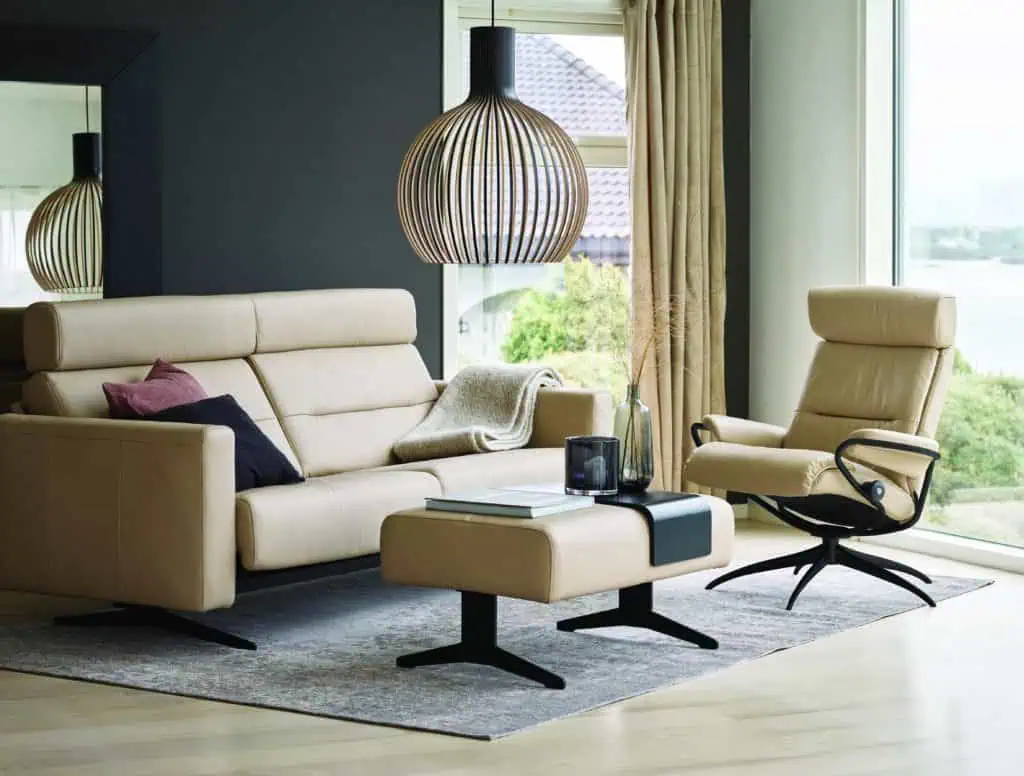 Stressless couch, chair, and ottoman in white upholstery arranged in living area
