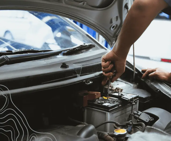 man fixing car's battery