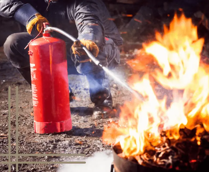 man kills fire using fire extinguisher