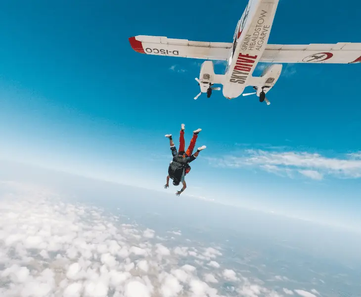 skydivers jump out of a plane