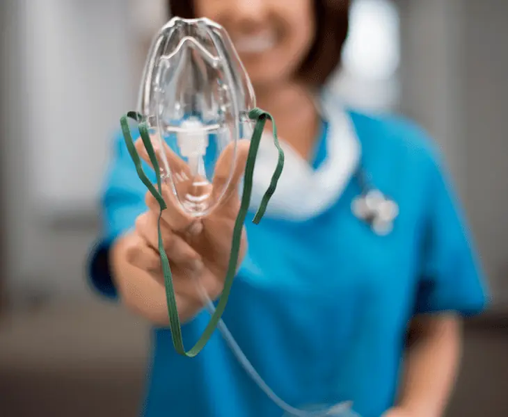 nurse holding oxygen mask