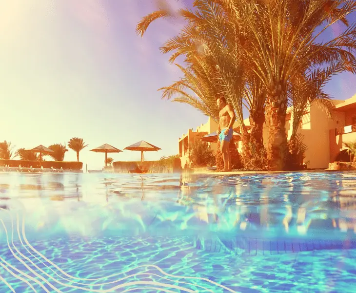 a man standing beside the pool