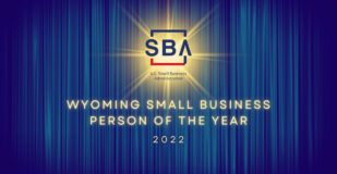 U.S. Small Business Administration logo on a blue curtain background. Text reads Wyoming SMall Business Person of the Year 2022