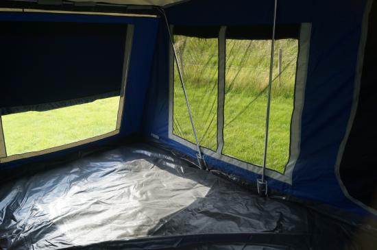 Outdoor trailer tent with awning for camping comfort and convenience.