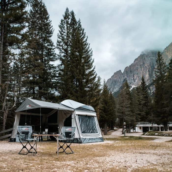 Off-road Trailer with Family Tent in Forest Setting.