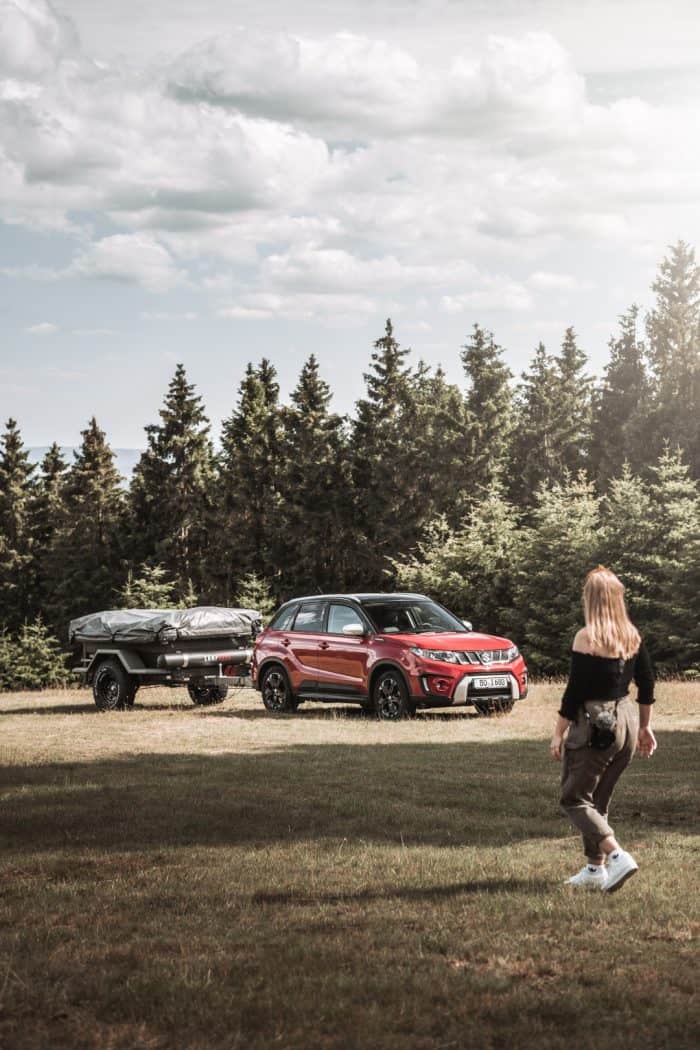 Off-road trailer and family tent setup in nature at Yellystone Outdoors.