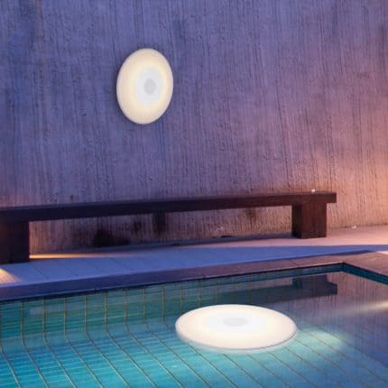 Floating light and music device in pool for outdoor fun.