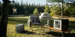 Portable power station outdoors with camping setup and appliances.