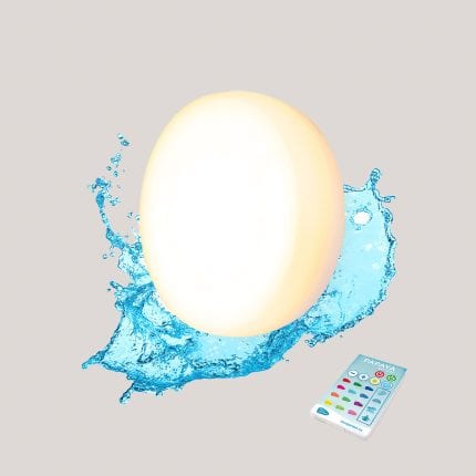 Egg with water splash and remote control, highlighting freshness and technology.