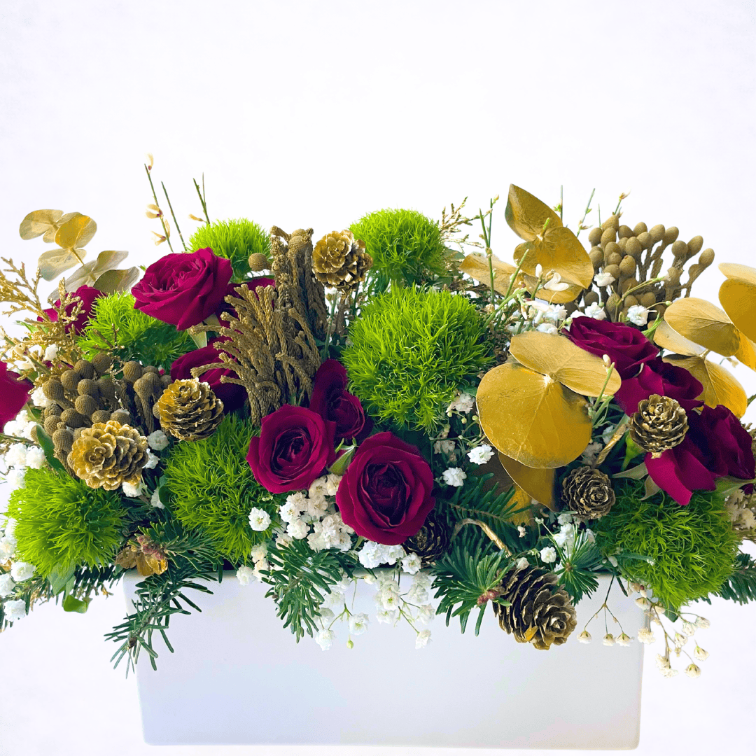 Luxury Christmas centerpiece with red roses and evergreen textures