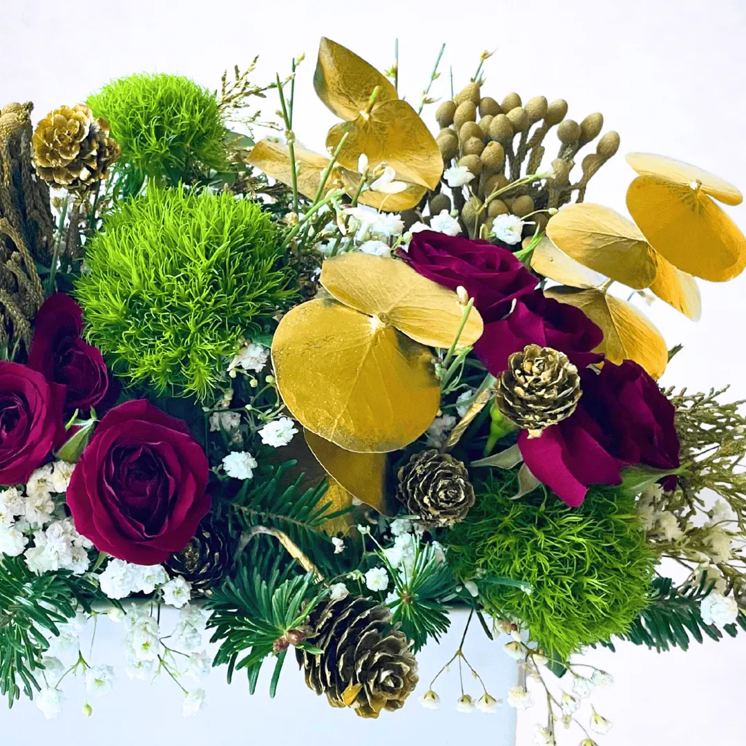 Luxury Christmas centerpiece with red roses and evergreen textures
