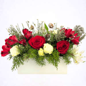 Luxury winter evergreen centerpiece with roses and pinecones