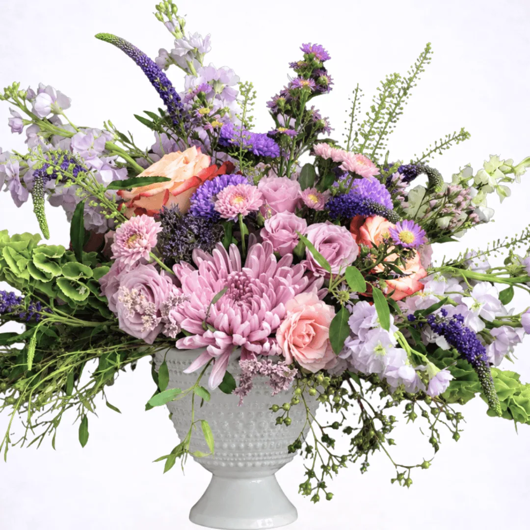 Luxury lavender garden style flower arrangement in white pedestal vase