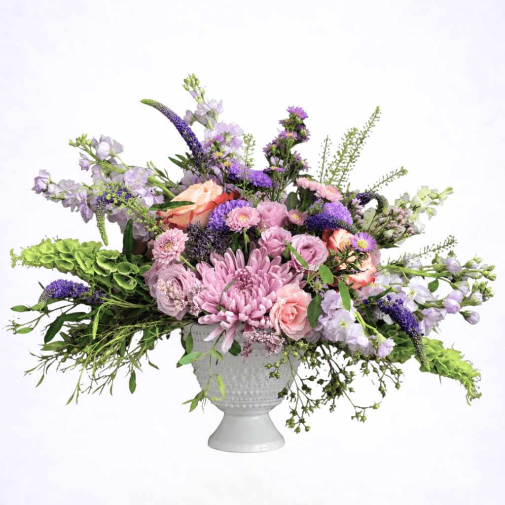 Luxury lavender garden style flower arrangement in white pedestal vase