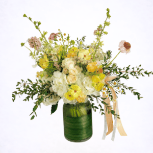 Luxury buttercream garden flower arrangement in green glass vase