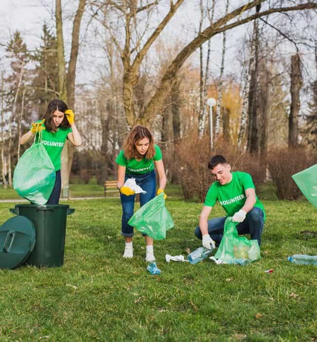 Recycling and cleaning up outdoors with volunteers in a park environment for waste management and environmental conservation.