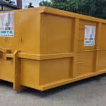 Large yellow dumpster for waste collection and junk removal services.