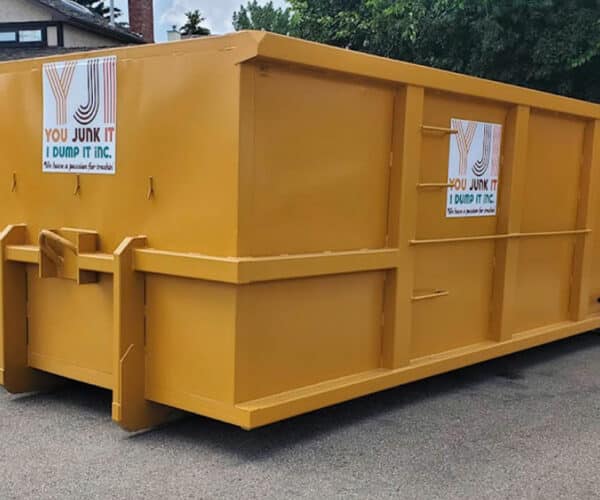 Large yellow dumpster for waste collection and junk removal services.