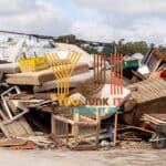 Scrap furniture and household waste at a junk removal site for recycling and disposal.