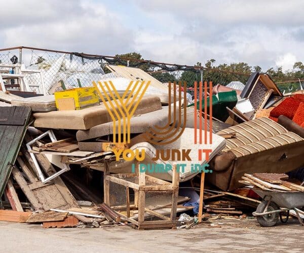 Scrap furniture and household waste at a junk removal site for recycling and disposal.