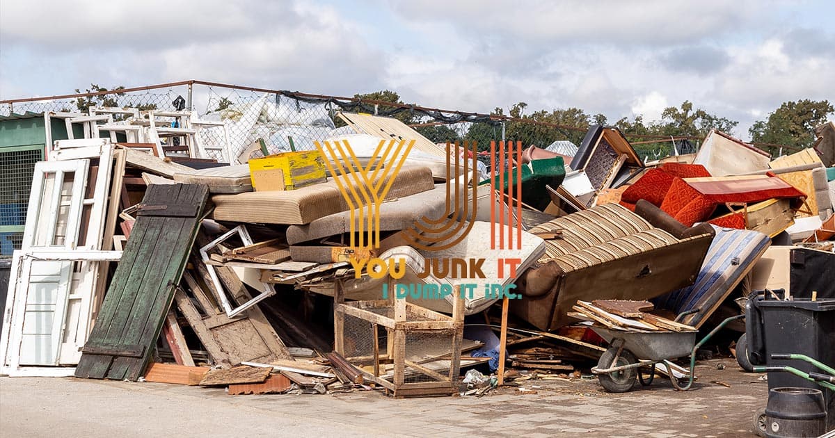 Scrap furniture and household waste at a junk removal site for recycling and disposal.
