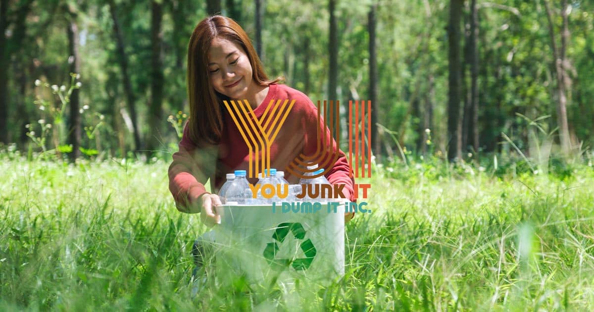 Recycling trash bin with plastic bottles outdoors in nature, eco-friendly waste disposal You Junk It I Dump It recycling services, environmental waste removal.