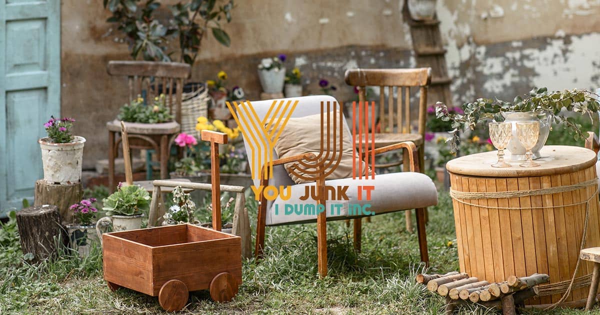 Vintage outdoor garden furniture and decor with wooden planters, chairs, and a barrel table, suitable for junk removal and disposal.