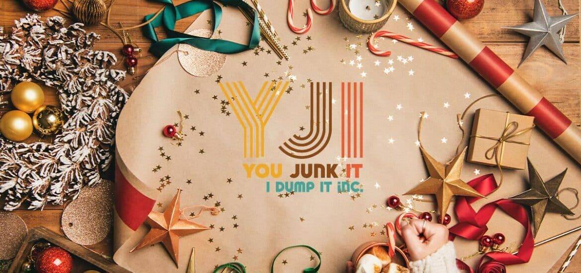 Christmas decoration items surrounded by wrapping paper, ribbons, and ornaments for holiday cleanup.