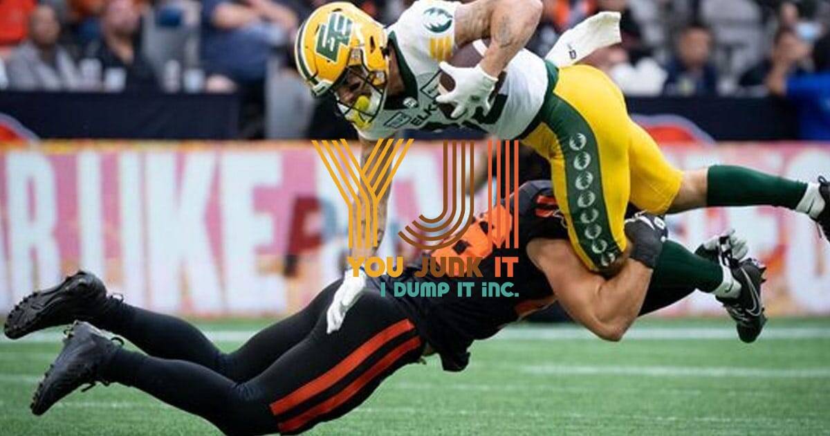 elks player running with a football into another player