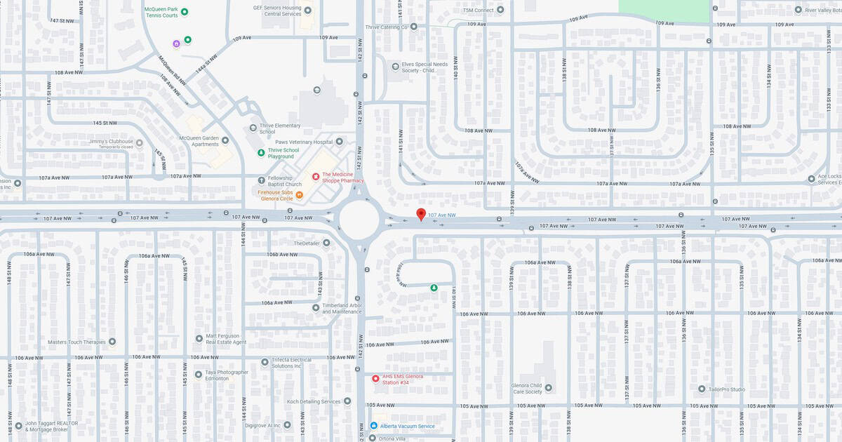 A detailed map of NW Edmonton showcasing a central roundabout at 107 Ave NW, with nearby schools, hospitals, churches, and local businesses.
