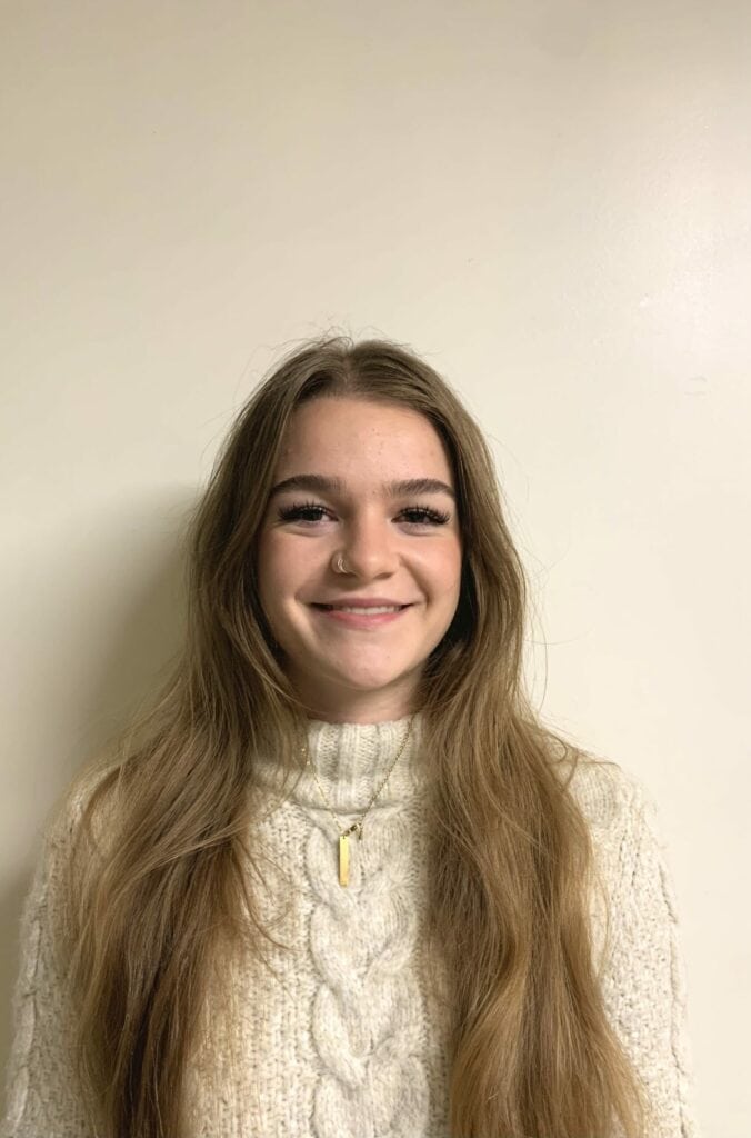 Young woman smiling, representing the proactive youth voice championed by Young Canadians for Resources (YCR) in Canadian natural resources development.