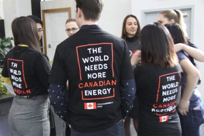 Young Canadians for Resources group wearing "The World Needs More Canadian Energy" jackets at an event.
