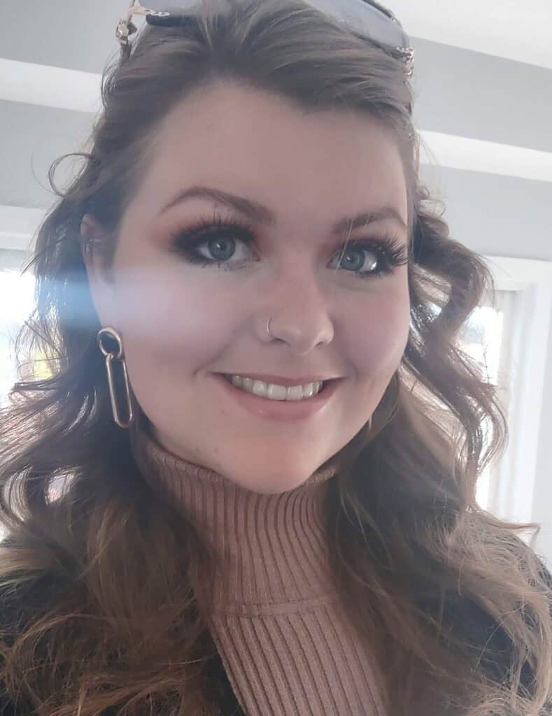 Young woman with wavy brown hair and striking blue eyes, representing youth engagement in Canadian resource sectors.