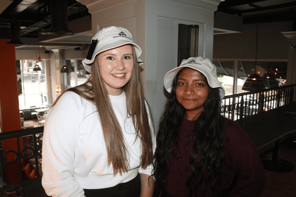 Young women wearing white hats at Young Canadians For Resources event.