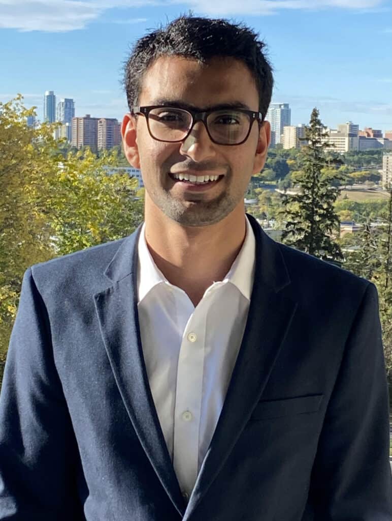 Young man in business suit with cityscape background - Young Canadians for Resources YCR promoting responsible resource development.