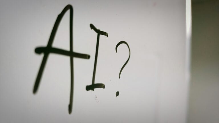 Alternative text: Metal hooks forming the letters "A" and "?" on a white background.