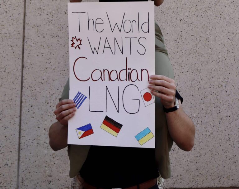 Canadian flag protest sign for resource development, advocacy for Canadian interests and policies.