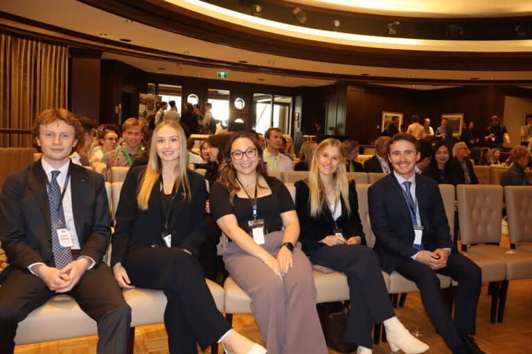 Diverse group of young professionals and students attending a conference or seminar.